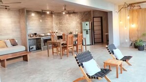 A modern living space with a kitchen, dining area, and seating area. - The sea in front of your window! (Puerto Vallarta)