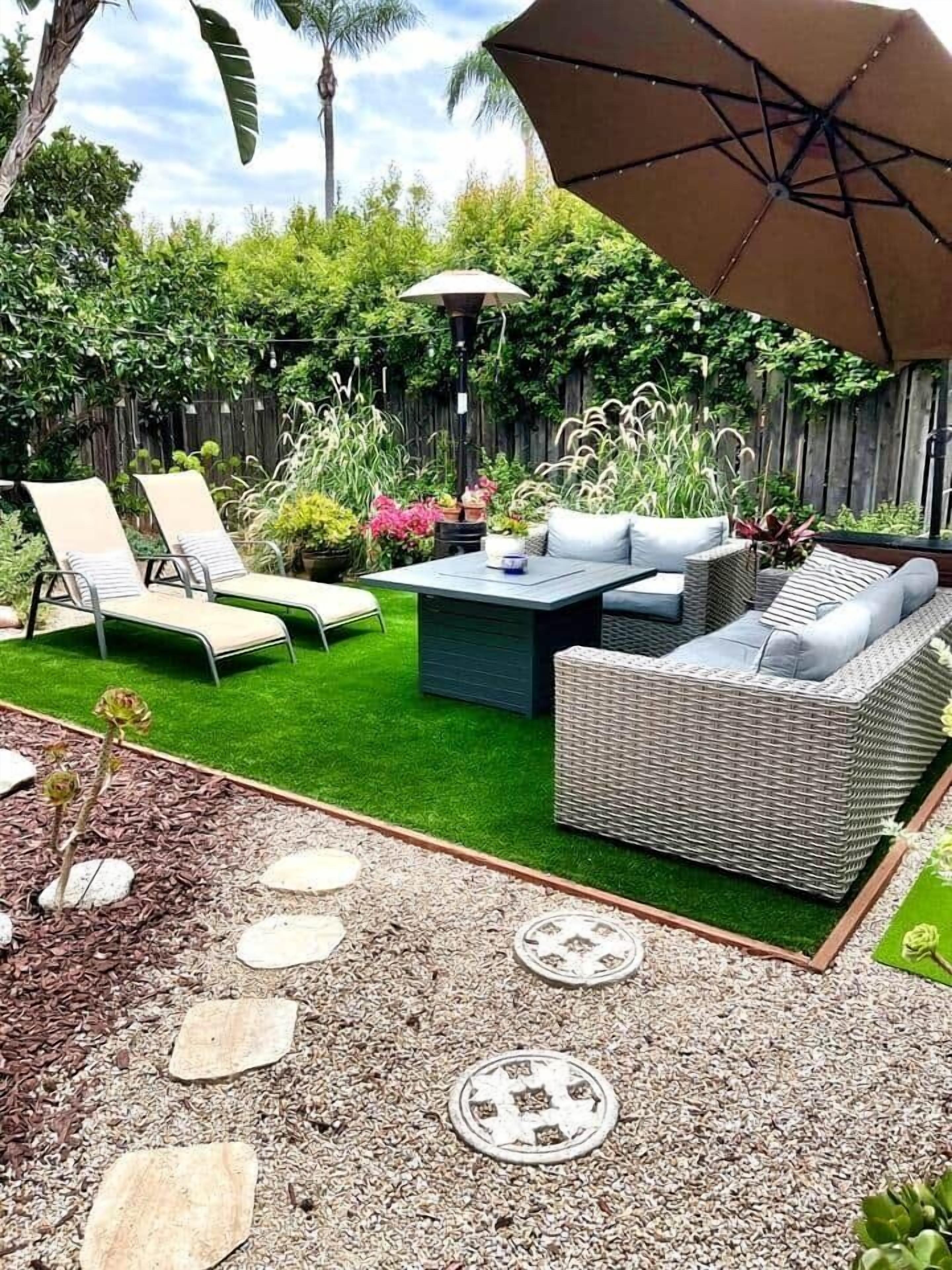 A patio with outdoor furniture, a table, and a large umbrella.