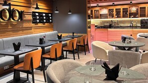 A modern restaurant with wooden beams, a bar area, and seating arrangements. - d'or Hotel (Codru)
