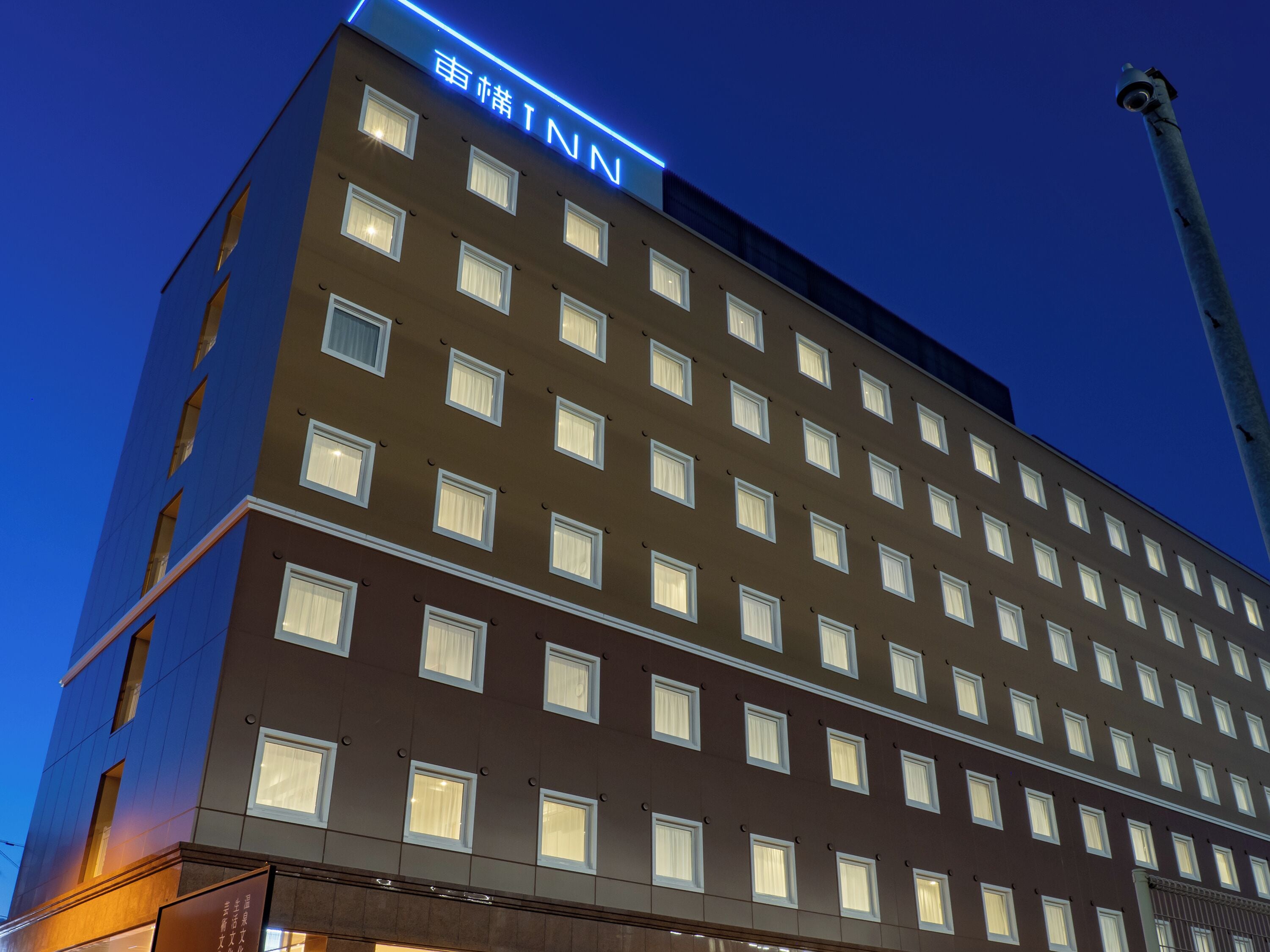 A multi-story hotel with a uniform facade, numerous windows, and a prominent signage at the top.