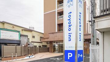 A sign for Toyako Inn with a parking direction sign.