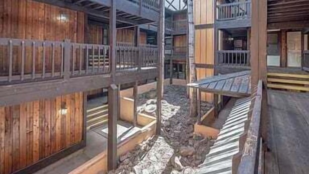 A traditional wooden building with multiple balconies and a central courtyard. - Walk to Slopes | Master ensuite | Snowfire 303B (Angel Fire)