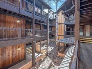 A traditional wooden building with multiple balconies and a central courtyard. - Walk to Slopes | Master ensuite | Snowfire 303B (Angel Fire)