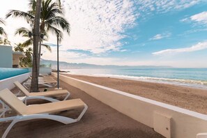 On the beach, sun-loungers, beach towels - Beachfront Studio,  New & Cozy,   Stunning Ocean Views,  Prime Location (Puerto Vallarta)