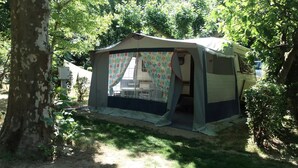 A tent with a table and chairs inside, surrounded by trees. - Gitotel 1-Bedroom Chalet for 2 People (ST JEAN DU GARD)