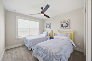 A bedroom with two beds, a ceiling fan, and two wall-mounted lamps. - 5-Min Walk to Beach | Good Morning Rentals (Jacksonville Beach)