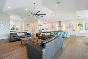 A modern living room with a sofa, coffee table, and a ceiling fan. - Yacht Sea (Anna Maria)