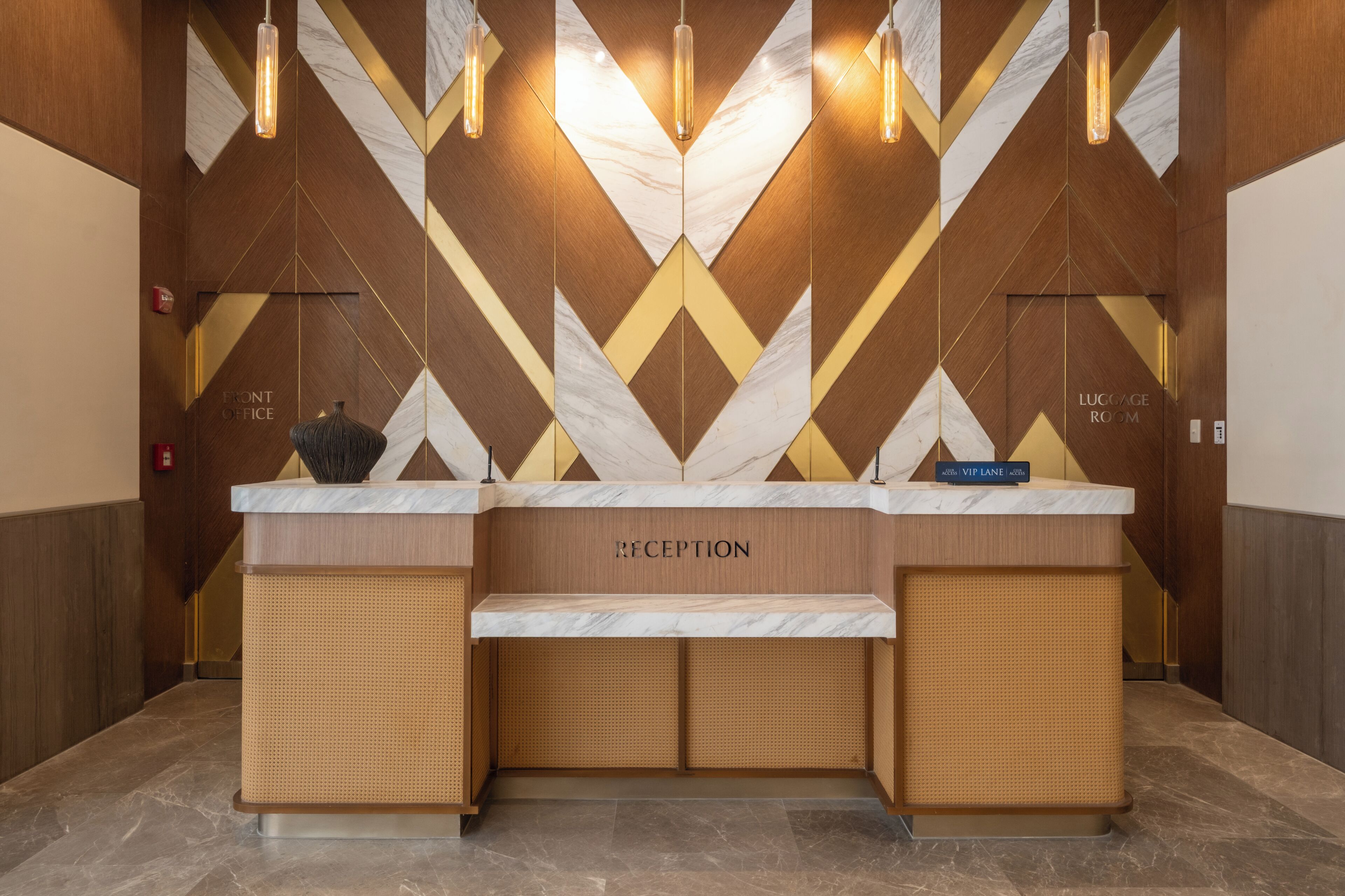 A reception desk with a 'RECEPTION' sign, a 'VIP LANE' sign, and a 'FRONT OFFICE' sign.