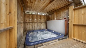 A wooden hot tub with a white cover, surrounded by wooden walls and a wooden deck. - Private Suite, Hot Tub, Bikes, Fireplace, King Bed, stroll to easy beach access (Depoe Bay)