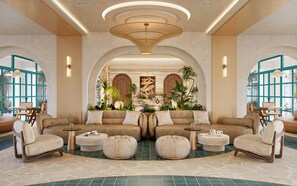 A spacious lobby with a central seating area, large windows, and a decorative ceiling. - La Vita Bliss Phu Quoc (Duong To)