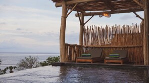 A wooden structure with two lounge chairs and a view of the sea. - Angsoka Villas Amed (Karangasem)