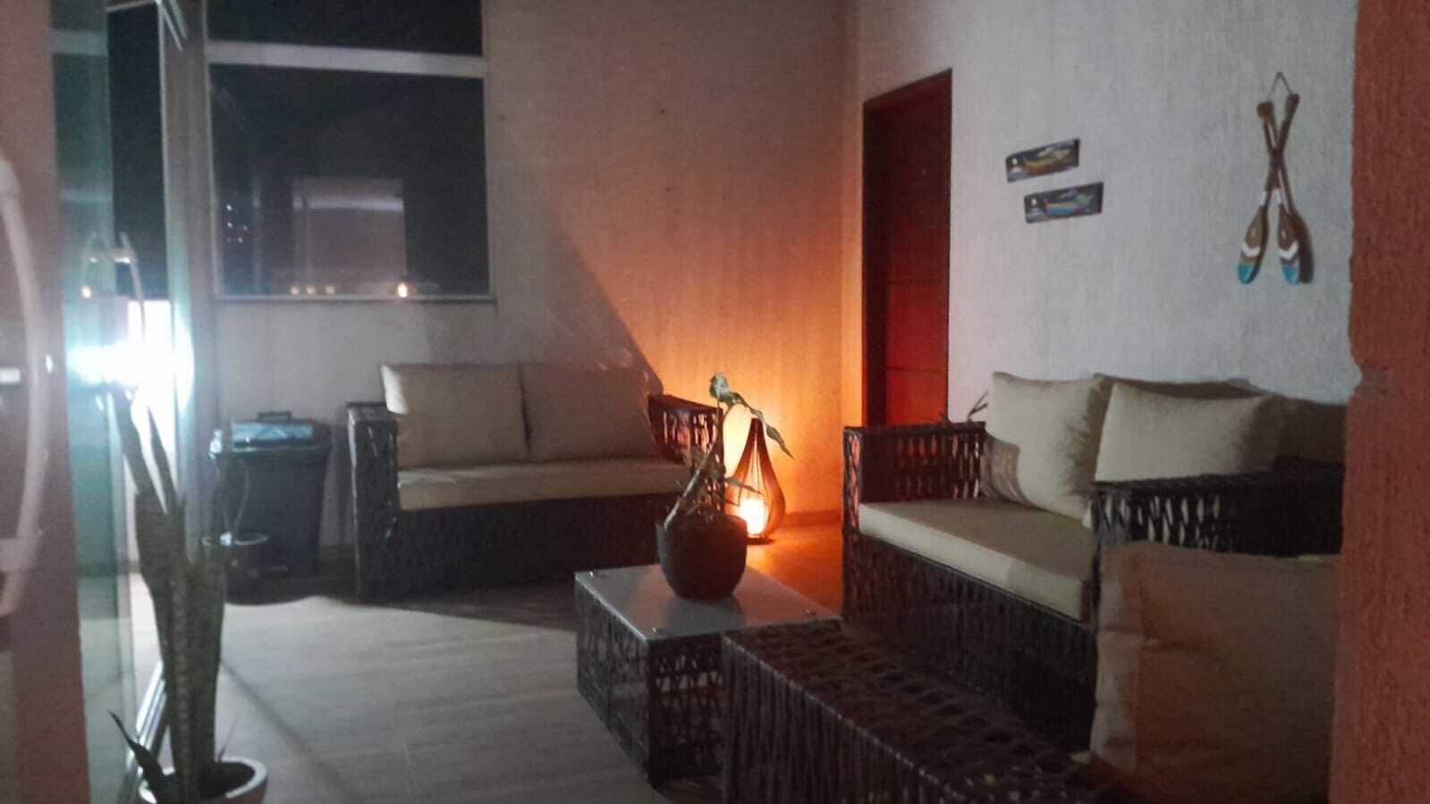 A living room with a sofa, a coffee table, and a lamp.