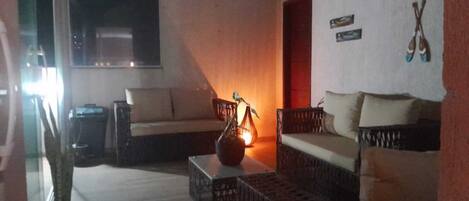A living room with a sofa, a coffee table, and a lamp.