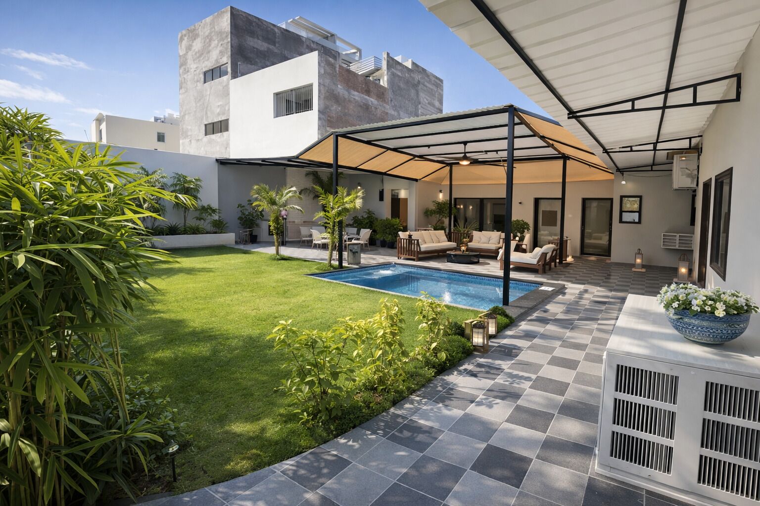 A modern outdoor patio with a pool, seating area, and a covered section.