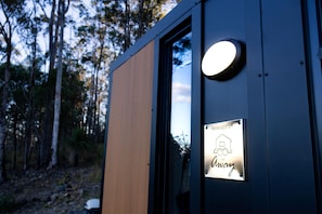 A wooden door with a sign indicating 'Managed by Tiny Away.'