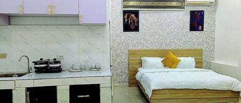 A bedroom with a wooden bed, a nightstand, and a small table with a lamp.