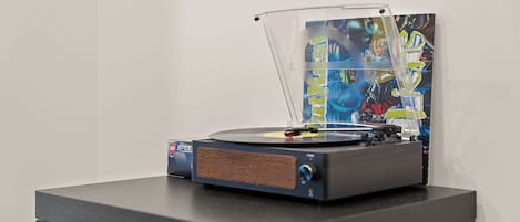 A turntable with a record player on a table.