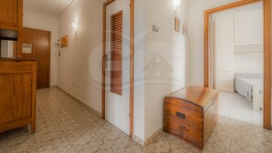 A hallway with a wooden cabinet, a door with a window, and a wooden chest of drawers. - CASA SILVIA SUL LUNGOMARE DI CAMPO - SILVIA SUL LUNGOMARE DI CAMPO (Campo nell'Elba)