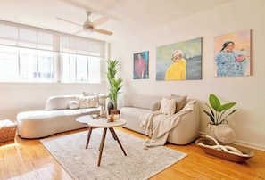 A modern living room with a sofa, a coffee table, and artwork on the walls. - Beautiful Curated And Designed Flat In Polanco (Ciudad de México)