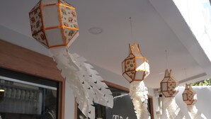 Hanging paper lanterns and a shop with a sign reading "Trybe Capsules". - Trybe Capsule Hostel Chiang Mai (Chiang Mai)