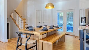 A modern kitchen with a wooden island, white cabinetry, and a stainless steel refrigerator. - Spacious 6BR/5BA - Near DC & Pentagon (Arlington)