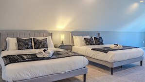 Two adjacent beds with grey headboards, white bedding, and patterned throw pillows. - Spacious 6BR/5BA - Near DC & Pentagon (Arlington)