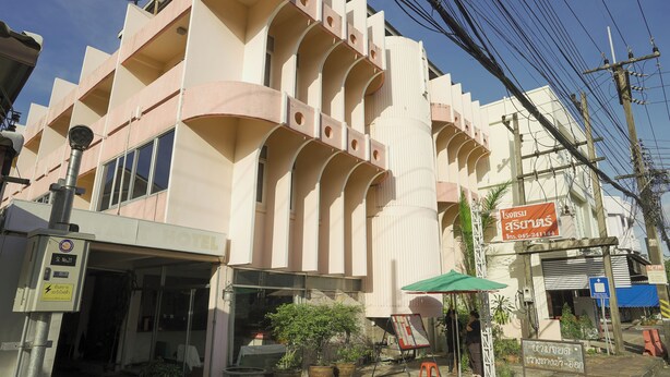 A hotel with a modern architectural design, featuring balconies and a prominent entrance. - Suriyart Hotel (Ubon Ratchathani)