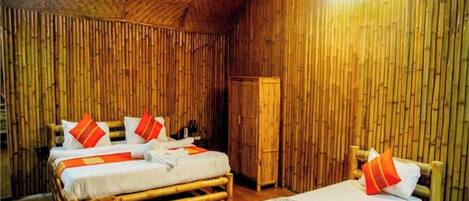 A room with two wooden beds, each with a pillow and a blanket.