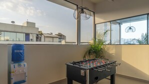 A modern indoor space with a foosball table and a water dispenser. - The Hosteller Hyderabad HITEC City (Hyderabad)