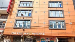 A multi-story building with a sign reading "HOTEL RA PALACE". - Hotel The Raj Palace (New Delhi)