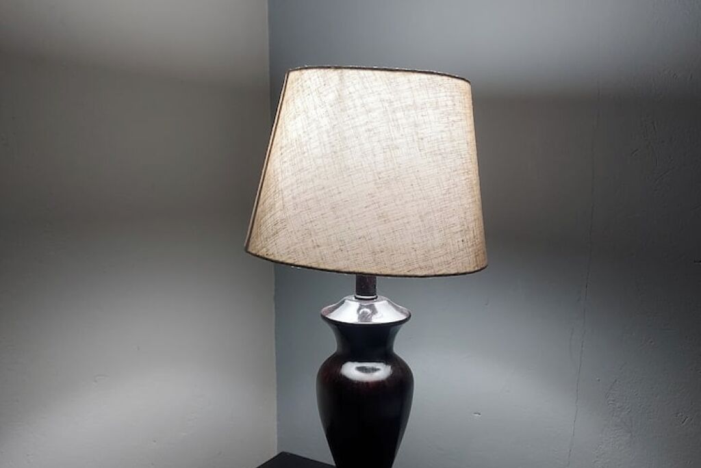 A lamp with a textured lampshade and a dark base.