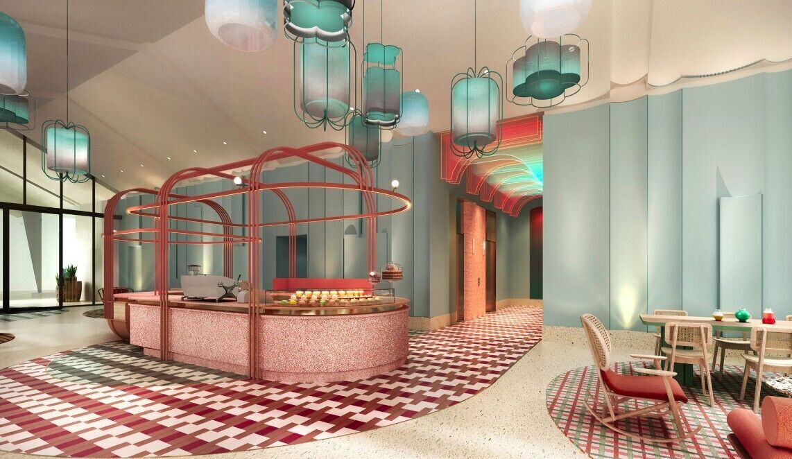 A modern interior with a central seating area, a patterned floor, and hanging light fixtures.