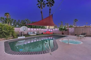 A swimming pool with a basketball hoop, lounge chairs, and a red shade sail. - Strip-Side Villa, 6 Beds, Pool, Mini Golf, Karaoke (Las Vegas)