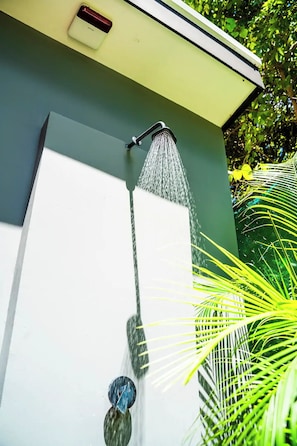 A wall-mounted water feature with a spout and a control knob. - New authentic Jungle Gem (Nosara)
