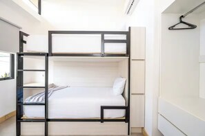 A bunk bed with a ladder, a white mattress, and a hanging black hanger.