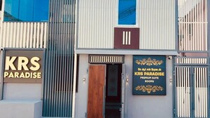 A modern building with a sign for 'KRS Paradise Premium Suite Rooms'. - KRS Paradise By  K Hotels  (Tiruvannamalai)