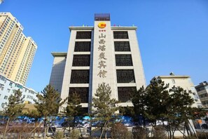 A multi-story building with a prominent vertical sign. - Shanxi Meitan Hotel (Taiyuan)