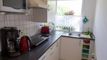 Fridge, microwave, stovetop, coffee/tea maker