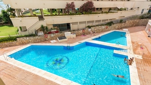 Une piscine sur le toit, dotée de plusieurs couloirs de nage, d’un poste de surveillance pour les sauveteurs et entourée d’un mur en pierre.