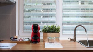 A kitchen with a coffee maker, a plant, and a sink. - Starflat Cozy central apartment NDK (Sofia)