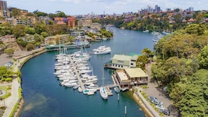 A marina with numerous boats docked, surrounded by residential buildings and greenery. - Mosman Bay - ROSE2 - Rose Crescent - Art Deco Mosman Bay home (Mosman)