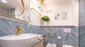 A bathroom with a large white sink, gold fixtures, a bidet, and a toilet. - Luxury Loft in Granada Center La Paz II (Granada)