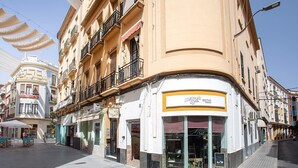 A street view with a building featuring a floral shop on the ground floor.