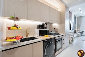Luxury Studio, Balcony, City View | Private kitchen | Full-size fridge, microwave, oven, stovetop - Vogue | Binghatti Dawn in JVC near Circle Mall (Dubai)