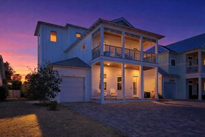 A two-story house with a covered front porch, a garage, and a small front yard. - Beach Please by Stay on 30a (Inlet Beach)