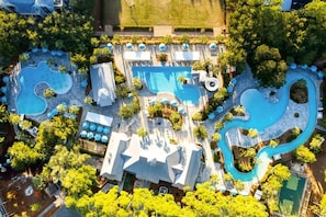 An aerial view of a resort with multiple swimming pools, lounge areas, and lush greenery. - Tall Timber Retreat by Stay on 30a (Watercolor)