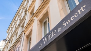 A building facade with a sign that reads "Le White by Sweettt." - Le White by Sweett (Paris)
