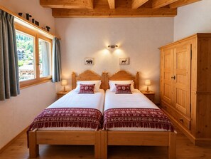 A double bed with two nightstands, a wooden wardrobe, and a window with curtains. - Modern 4-room duplex for 7 to 8 people 2 minutes from the ski lifts: 1 bedroom with double bed and b (Grimentz)