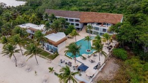 An aerial view of a resort with a pool, palm trees, and a beach area. - The Beachfront by The Fives Hotels Á la Carte - Adults Only (Playa del Carmen)