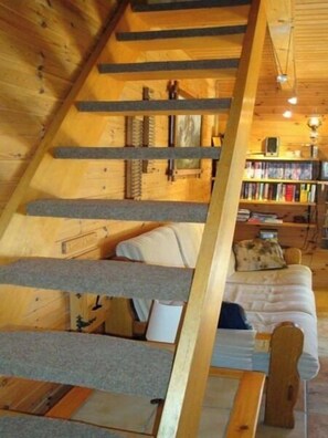 A cozy cabin interior with a loft bed, a wooden staircase, and a bookshelf filled with books. - Comfortable 4-room duplex  for 8 persons : Living room with fireplace - kitchen with dishwasher, ind (Grimentz)